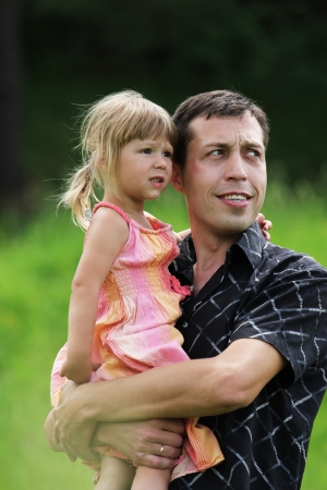 Beautiful little girl with her father on the natureの写真素材