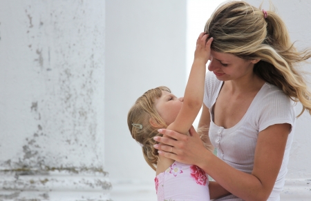 beautiful little girl with her mother outdoorsの写真素材