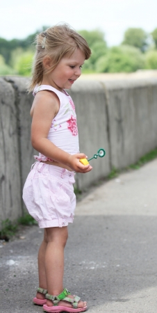 little girl with soap bubblesの写真素材