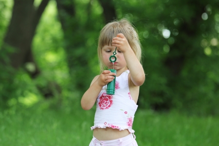 little girl with soap bubblesの写真素材