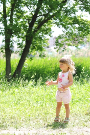 little girl with soap bubblesの写真素材