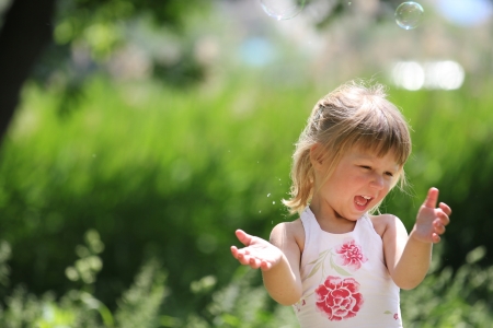 little girl with soap bubblesの写真素材