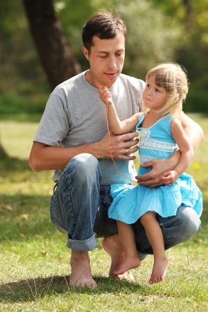 young father with his daughter on natureの写真素材