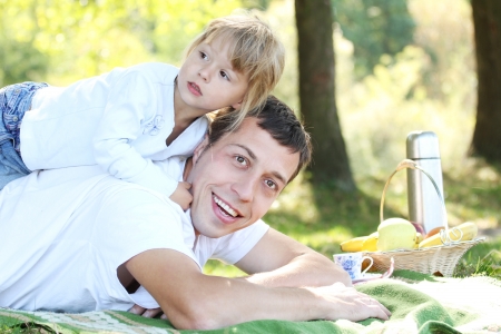 beautiful little girl play with dad in natureの写真素材