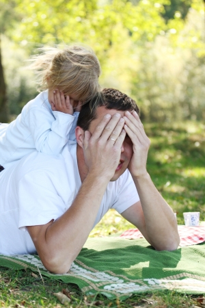 beautiful little girl play with dad in natureの写真素材