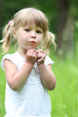 beautiful little girl on natureの写真素材