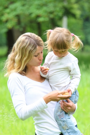 young mother and her little daughter on natureの写真素材