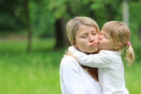 young mother and her little daughter on natureの写真素材