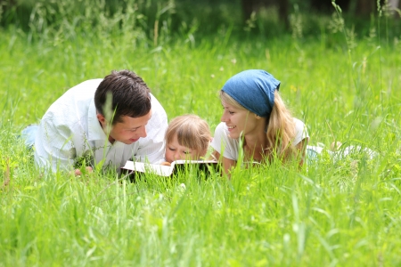 young family with a young daughter reads the Bibleの写真素材