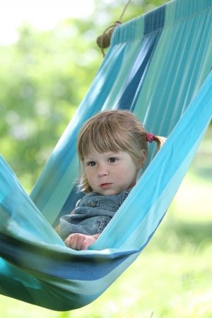 little girl on a hammock on natureの写真素材
