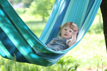 little girl on a hammock on natureの写真素材