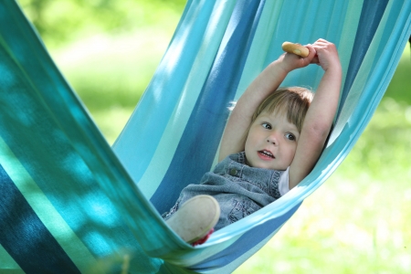 little girl on a hammock on natureの写真素材