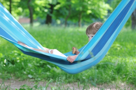 little girl on a hammock on natureの写真素材