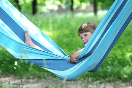 little girl on a hammock on natureの写真素材