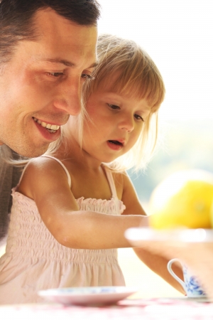 young father with young daughter at a picnicの写真素材