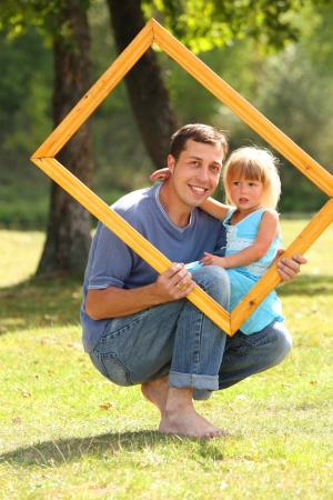 young father with baby daughter in a frameの写真素材