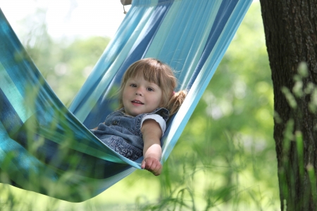 a very beautiful little girl on a hammockの写真素材