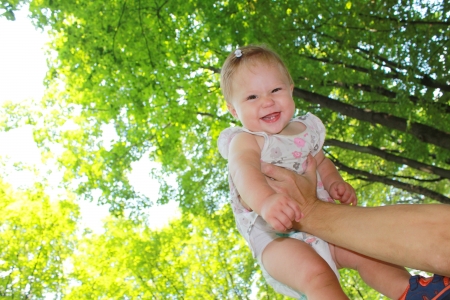beautiful little girl in my father's handsの写真素材