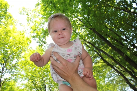 beautiful little girl in my father's handsの写真素材