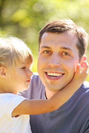 young father with his little daughter on natureの写真素材