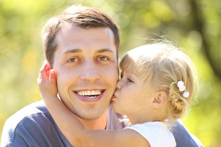 young father with his little daughter on natureの写真素材