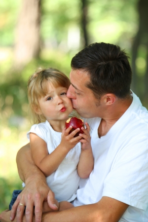 young father with his small daughter in a hammockの写真素材