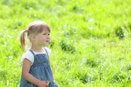 a little girl with soap bubblesの写真素材