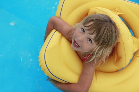 a girl swims in a pool with a circle