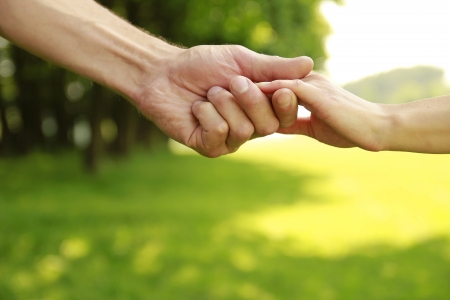 a two hands of a loving couple on natureの写真素材