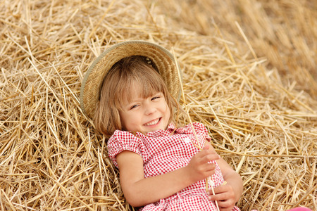 a little girl on the field with wheatの写真素材