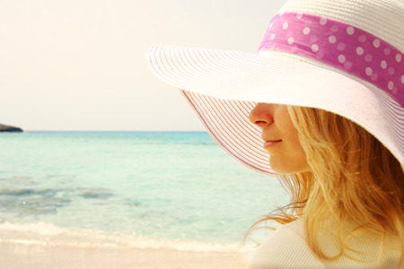 happy young girl in hat on the beachの写真素材