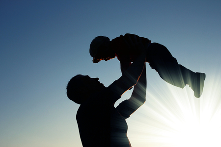 very nice silhouette of father and sonの写真素材