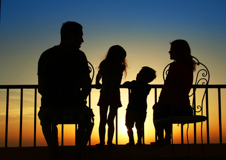 a Silhouette of a happy family at seaの写真素材