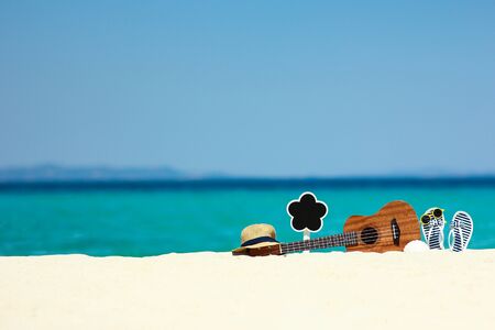 ukulele on the sand by the sea in summer nearthe beachの写真素材
