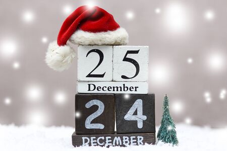 wooden christmas date with holiday backgroundの写真素材