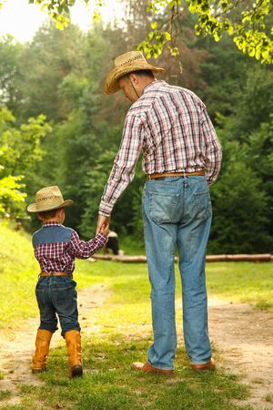 a  father and son of a cowboyの写真素材