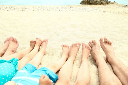 Family feet on the sand on the beach in summer
の写真素材