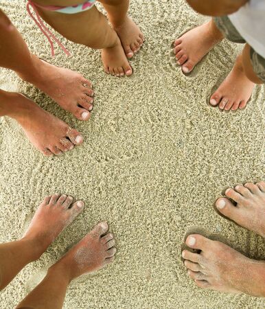 Family feet on the sand on the beach in holidayの写真素材