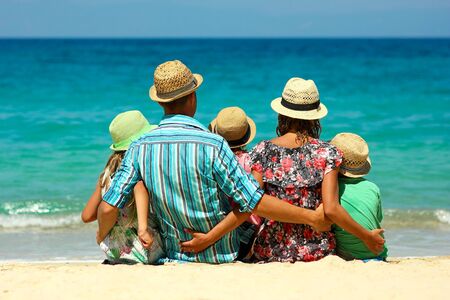 Happy family on the beach near seaの写真素材