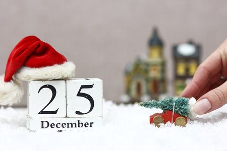 wooden christmas date with holiday background