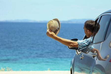 a driver in car at sea in summerの写真素材