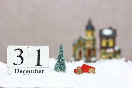 wooden christmas date with holiday backgroundの写真素材