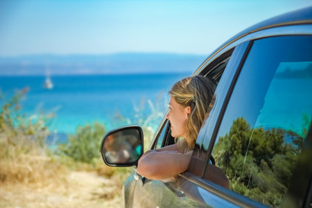 happy girl from car at sea greece backgroundの写真素材