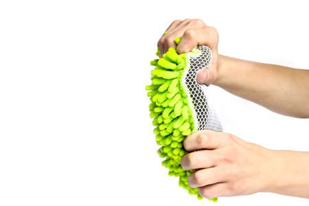 stylish sponge in hand on a white background for cars