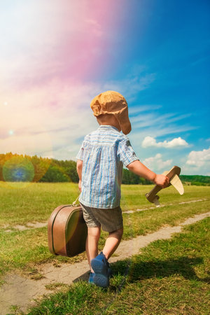 a  boy pilot with airplaneの写真素材