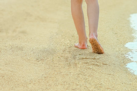 beautiful footprints in the sand by the sea backgroundの写真素材