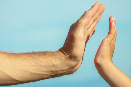 beautiful hands of parent and child by the seaの写真素材