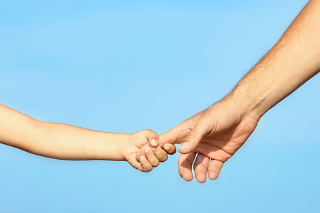 beautiful hands of parent and child by the seaの写真素材