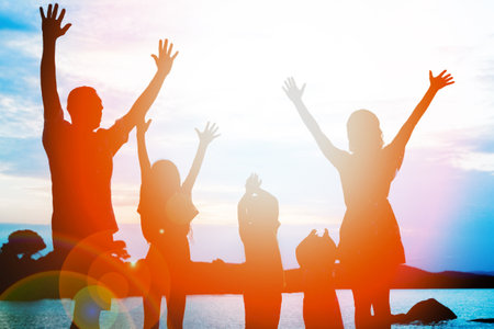 happy family by the sea on nature silhouette backgroundの写真素材