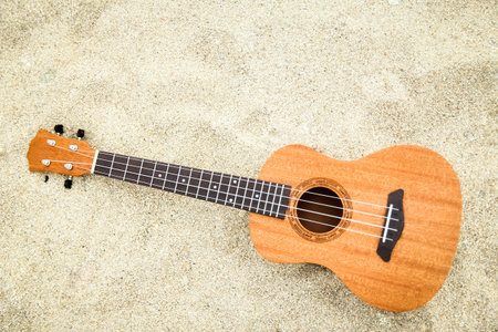 beautiful guitar on the sand by the Greek seaの写真素材